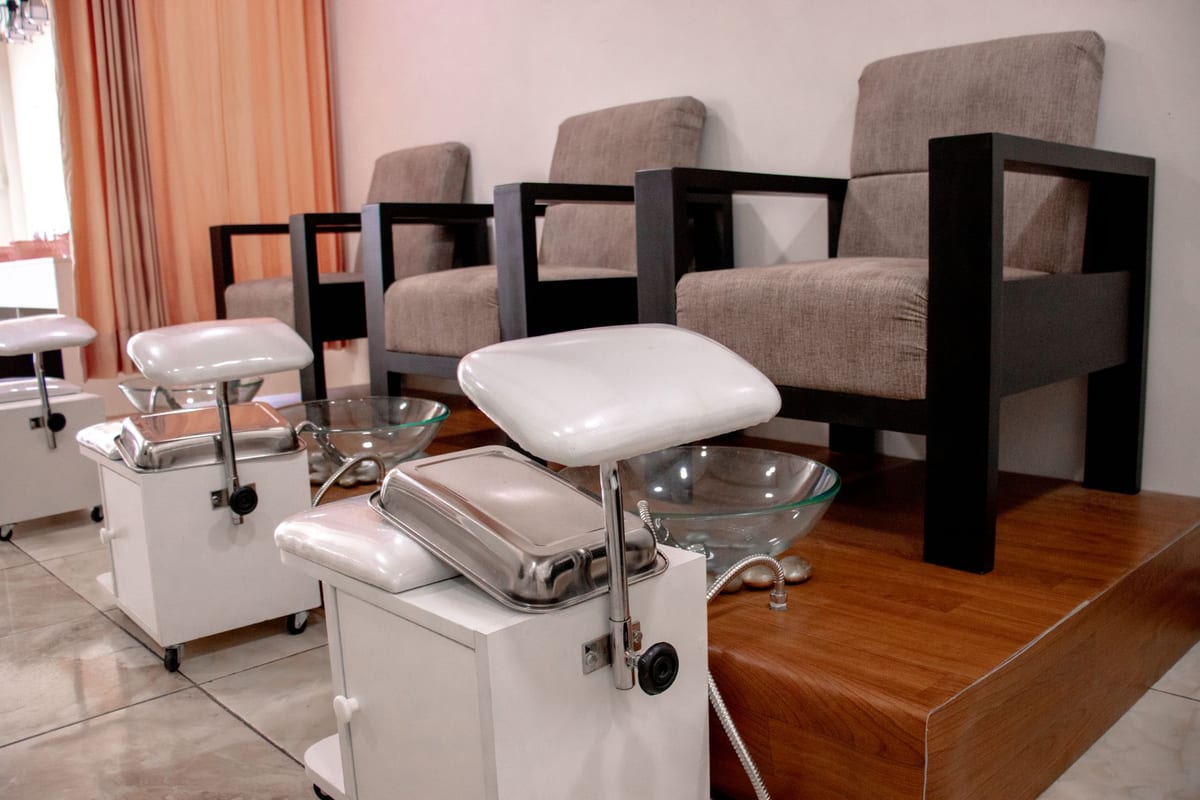 Pedicure chairs and foot spa stations inside a nail salon